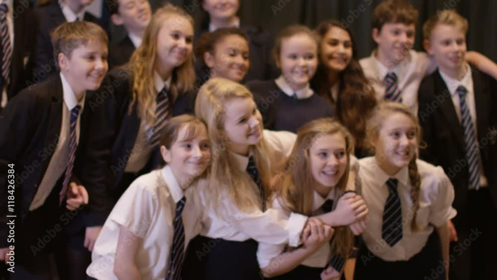 Teacher takes a photo of her students in school theatre. Teacher takes a photo of her students in school theatre.