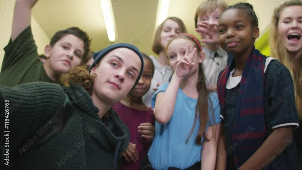 Happy diverse group of pupils pose for selfie in school hallway. Happy diverse group of pupils pose for selfie in school hallway.