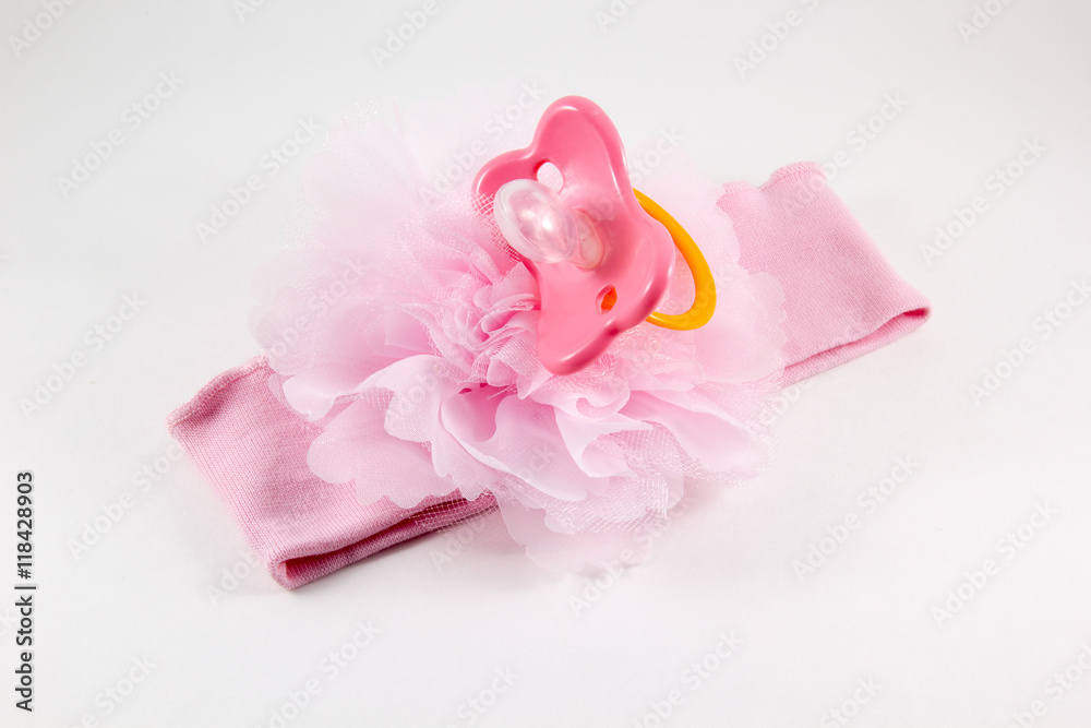 Pink bow and a nipple on a white background
