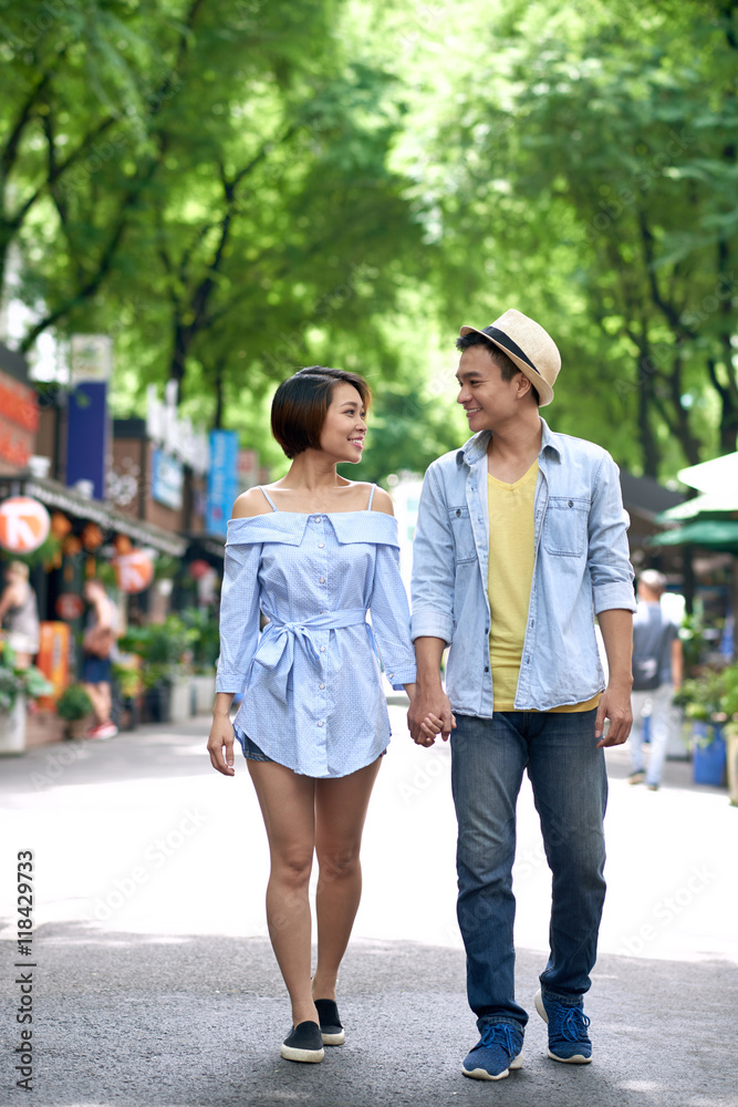 Vietnamese young couple walking in the street