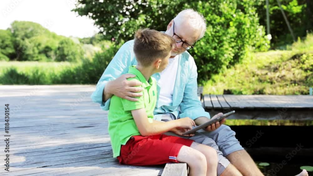 grandfather and boy with tablet pc on river berth 34 grandfather and boy with tablet pc on river berth 34
