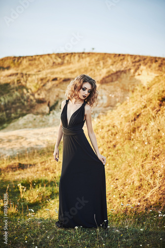 Very beautiful slim girl with long hair in a long dress © vitaliismulskyi