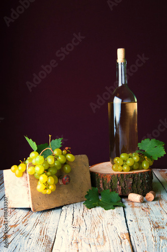 Bottle of white wine and grape