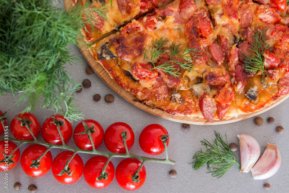 Italian pizza with cherry tomatoes, garlic and dill