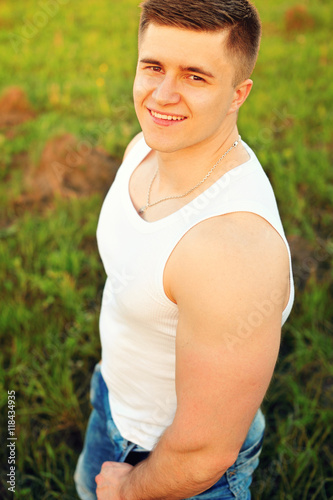 relaxed young guy lying on grass