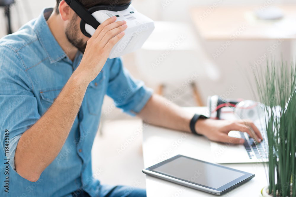 Pleasant man using virtual reality glasses Pleasant man using virtual reality glasses