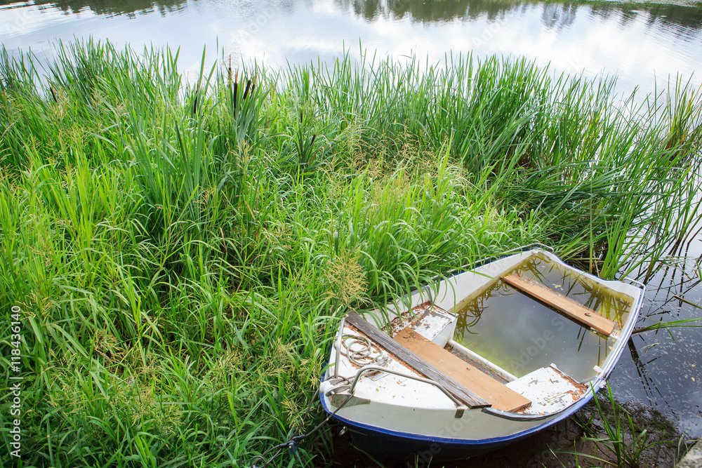 White rowing boat sunk in water White rowing boat sunk in water