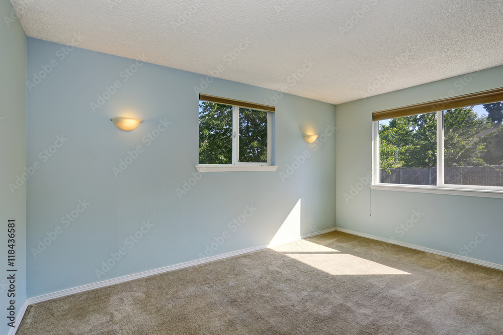 Light blue empty room interior with rustic wall lamps.