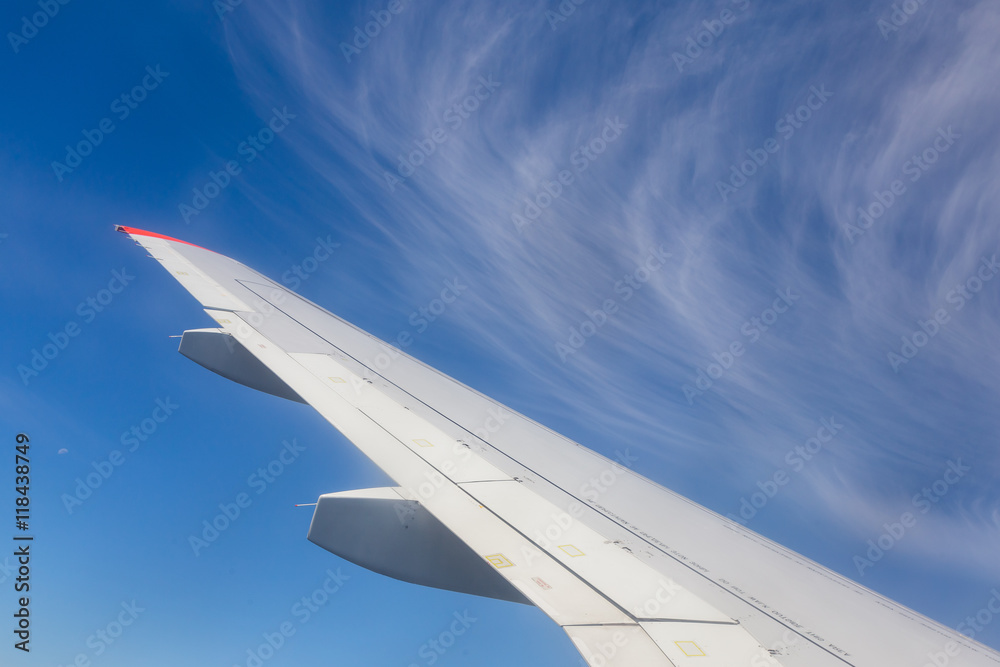 View from airplane window with blue sky and white clouds