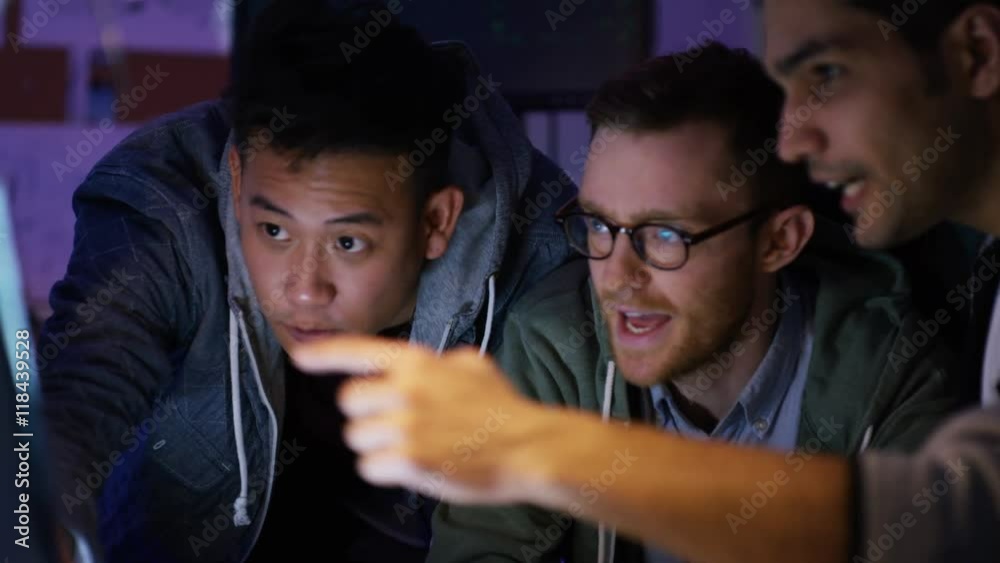  Team of young computer hackers trying to gain access to a computer system