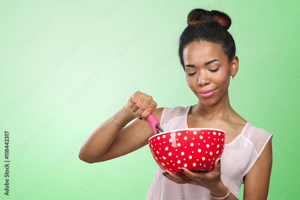 African american woman holding kitchen utensils African american woman holding kitchen utensils