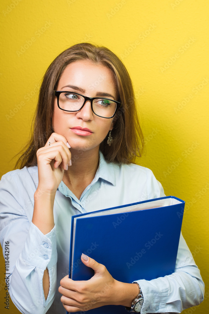 Smiling smart beautiful woman thinking about something and holding folder