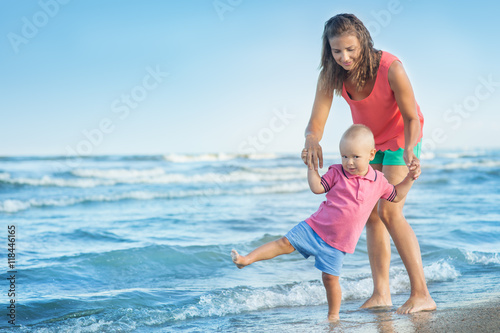 woman with a child playing on the beach