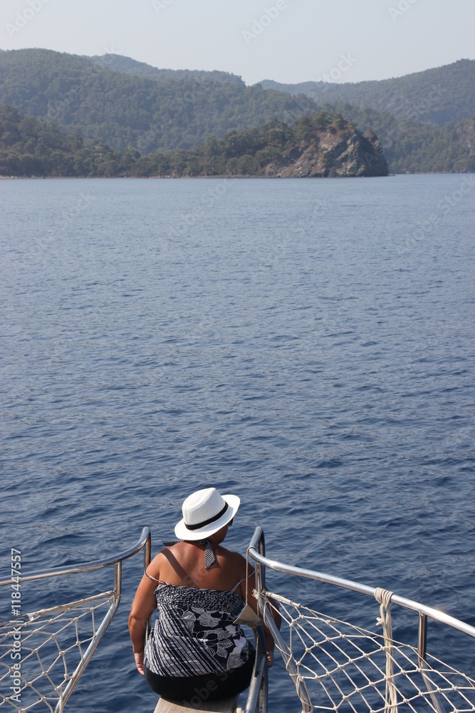 An english lady relaxing while on a boat trip around the bays at fethiye in turkey, 2016
