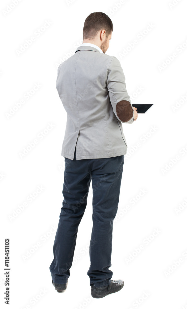 back view of business man uses mobile phone. rear view people collection. Isolated over white background. backside view of person. The bearded man in a gray jacket, working on the tablet. back view of business man uses mobile phone. rear view people collection. Isolated over white background. backside view of person. The bearded man in a gray jacket, working on the tablet.