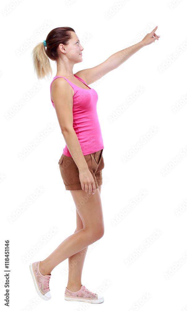 back view of pointing walking woman. going girl pointing. backside view of person. Rear view people collection. Isolated over white background. Sport blond in brown shorts walks past the camera back view of pointing walking woman. going girl pointing. backside view of person. Rear view people collection. Isolated over white background. Sport blond in brown shorts walks past the camera