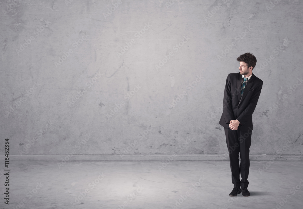 Young businessman standing confused