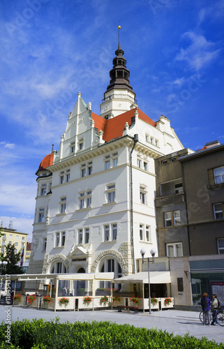 Town hall / City hall, Opava, Silesia, Czech Republic / Czechia - main landmark of Silesian town. Pedestrians, outside sitting and street life around building photo