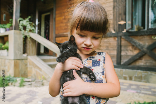 girl playing with kittens on the terrace