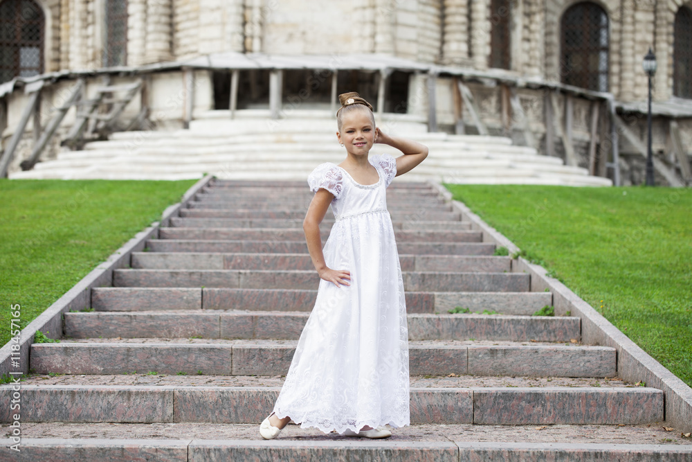 Portrait of a beautiful young little girl in white gown Portrait of a beautiful young little girl in white gown