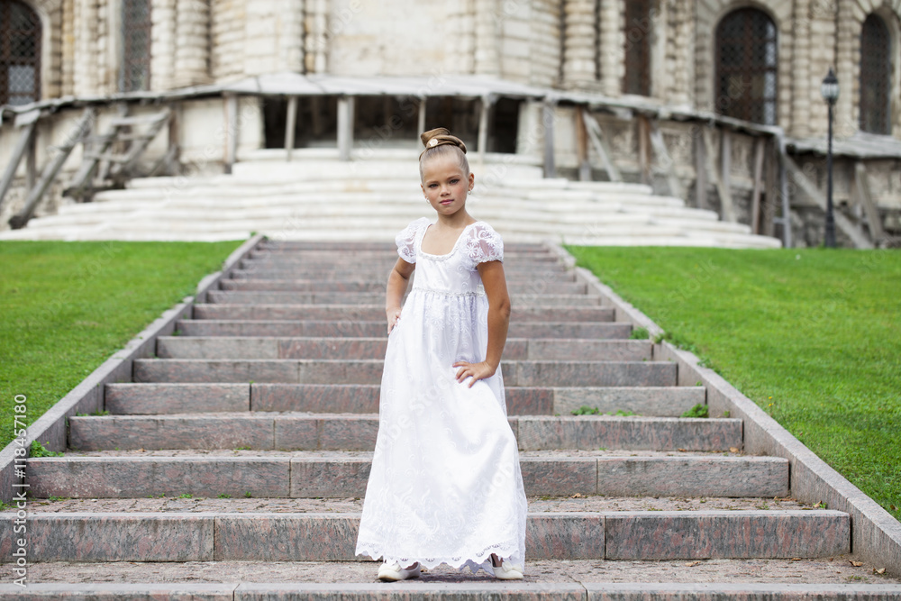 Portrait of a beautiful young little girl in white gown Portrait of a beautiful young little girl in white gown