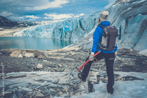 Woman climber standing near Jostedalsbreen glacier. photo