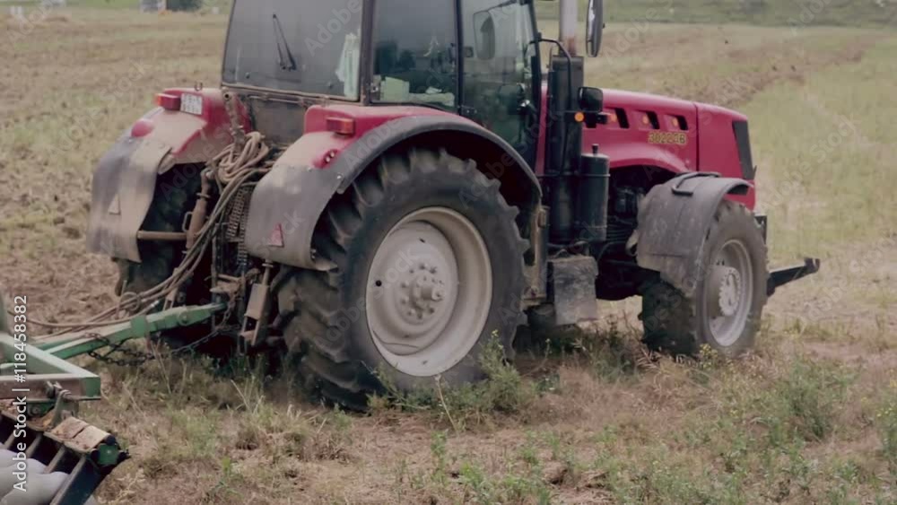 An agricultural tractor, plowing a field for sowing, turning right. An agricultural tractor, plowing a field for sowing, turning right.