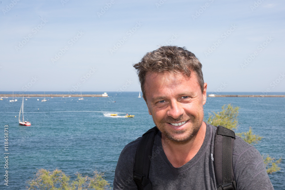 Handsome male posing in front of sea summer vacation