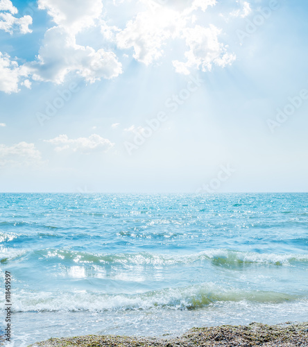 wave on sea and clouds in blue sky with sun