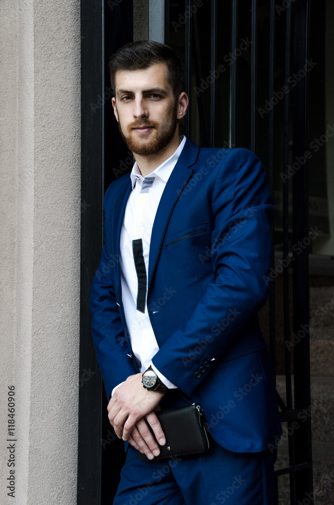 Handsome man in the jacket on a building background