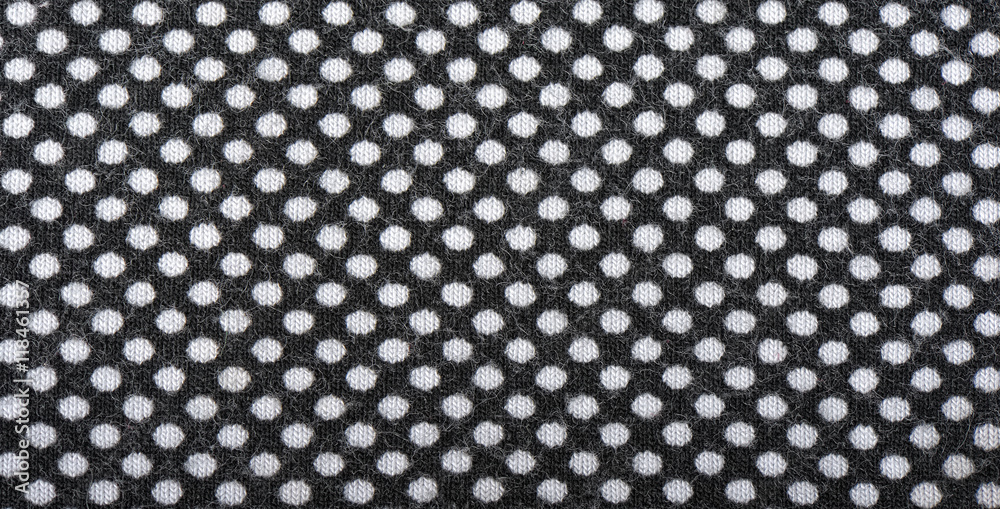 Dark knitted fabric with white polka dots, background Dark knitted fabric with white polka dots, background