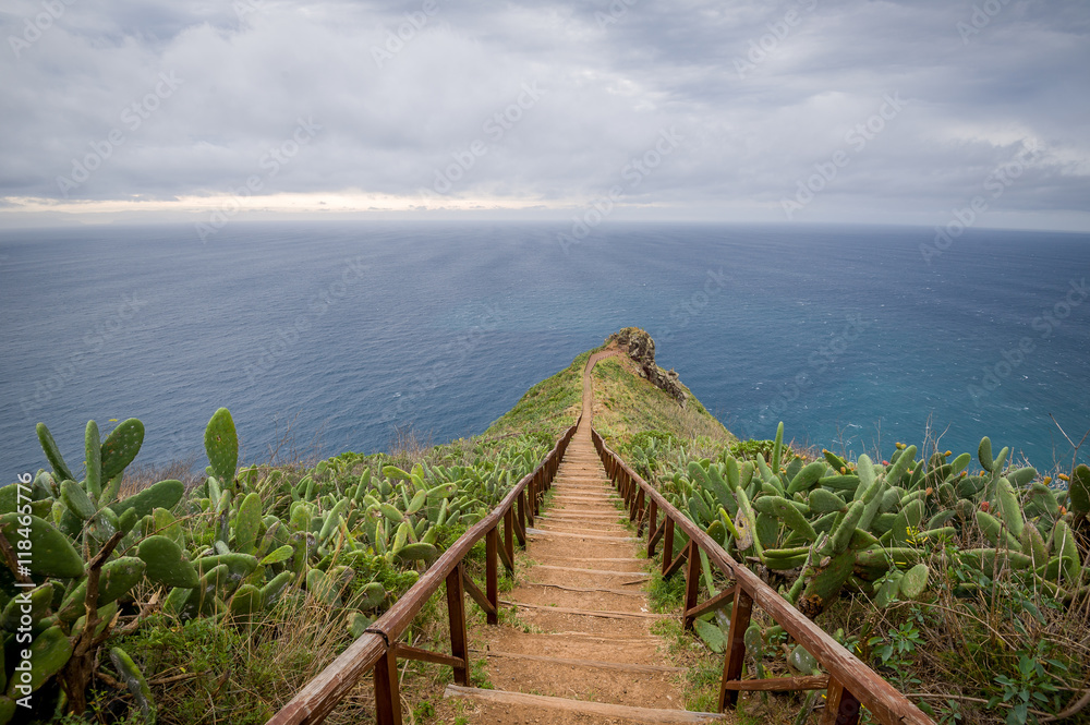 Wooden steps path from Cristo Rei statue to the ocean cape.