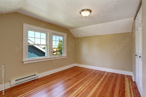 Empty room interior with beige walls and hardwood floo