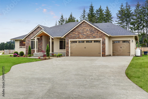 Luxury one level house exterior with brick trim and garage photo