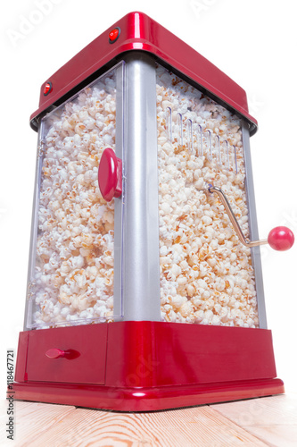 Red and gray full popcorn maker on table