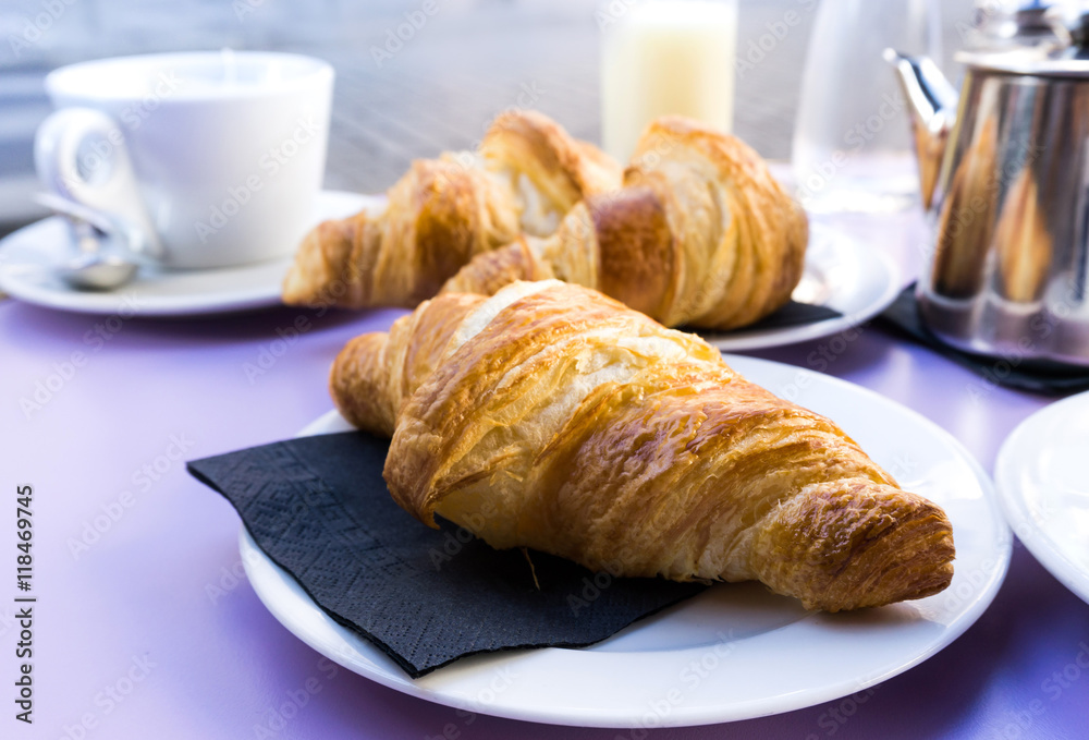Breakfast with coffee and croissants on table Breakfast with coffee and croissants on table