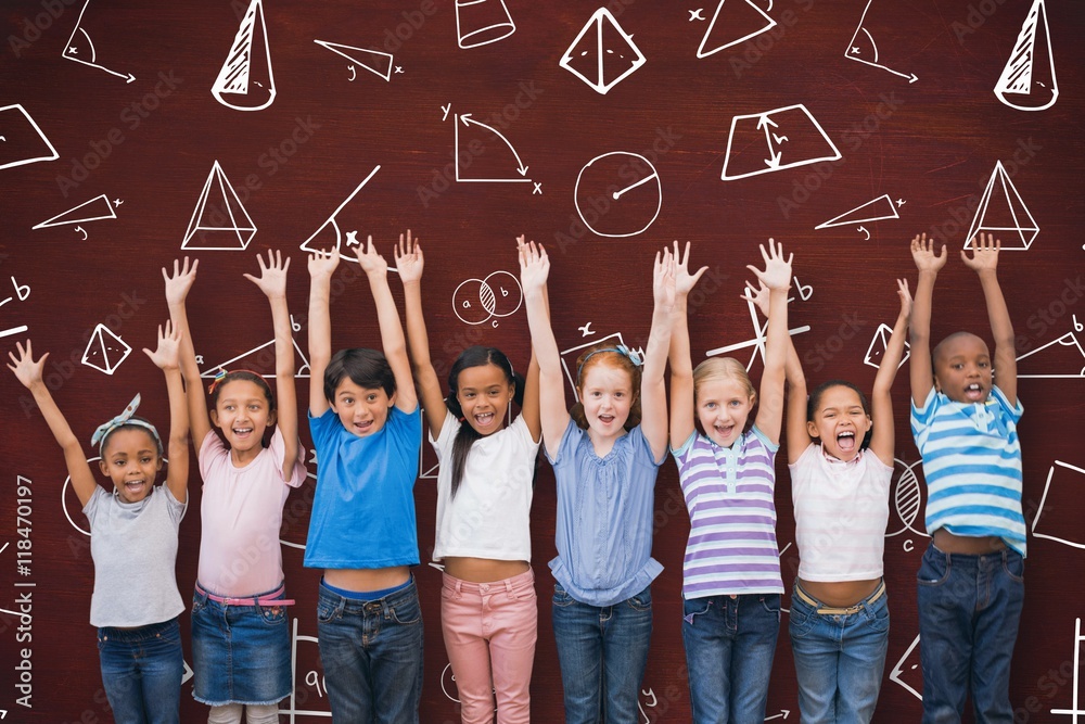 Fototapeta premium Composite image of cute pupils smiling at camera in classroom