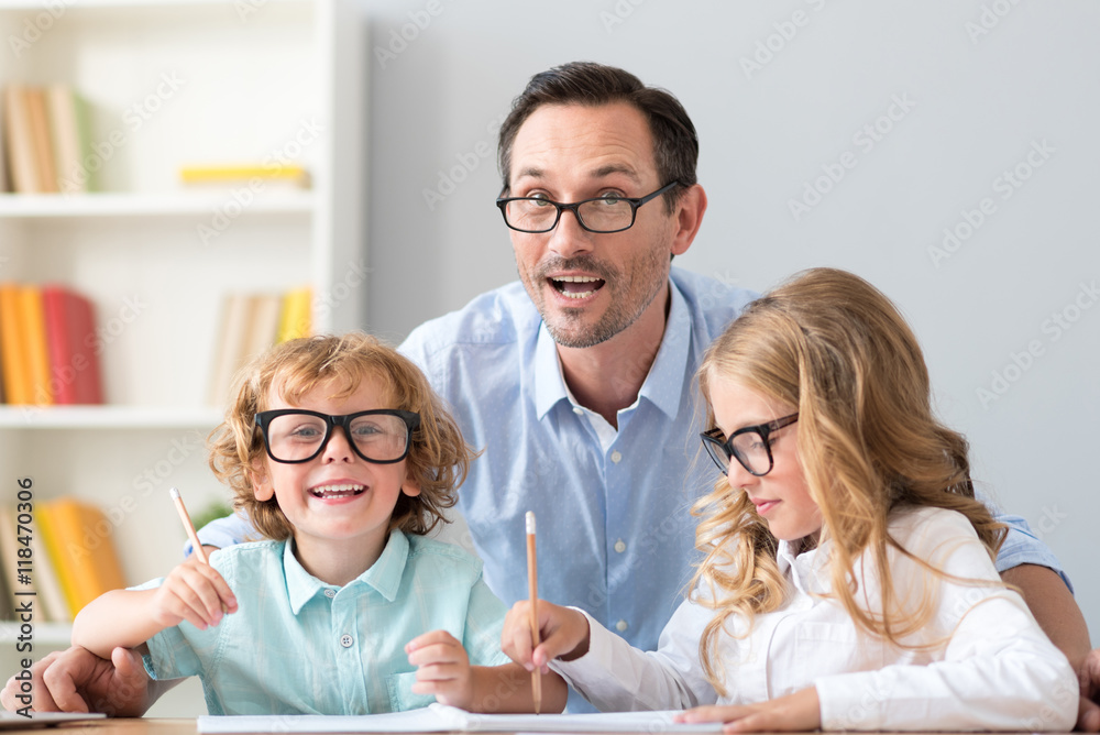 Family sitting at table and drawing Family sitting at table and drawing