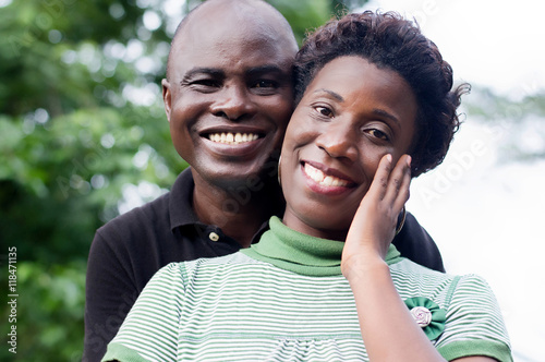 happy young couple embracing on a green background.