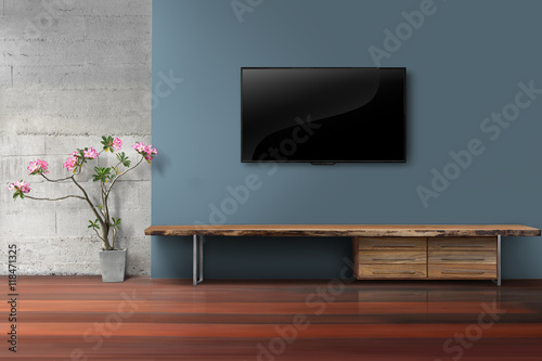 Living room led tv on blue concrete wall with empty wooden stand