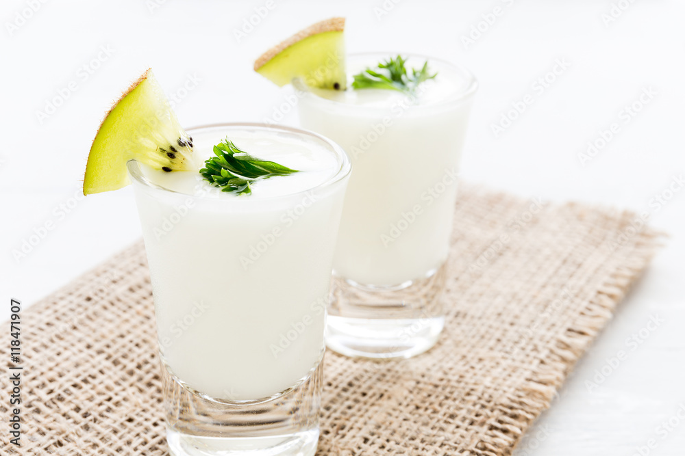Yogurt mix with green kiwi on white background