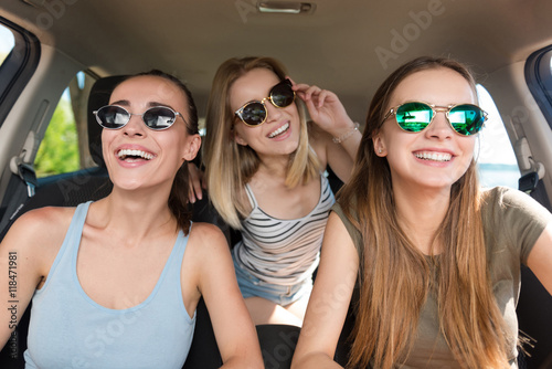 Positive smiling friends driving a car © zinkevych