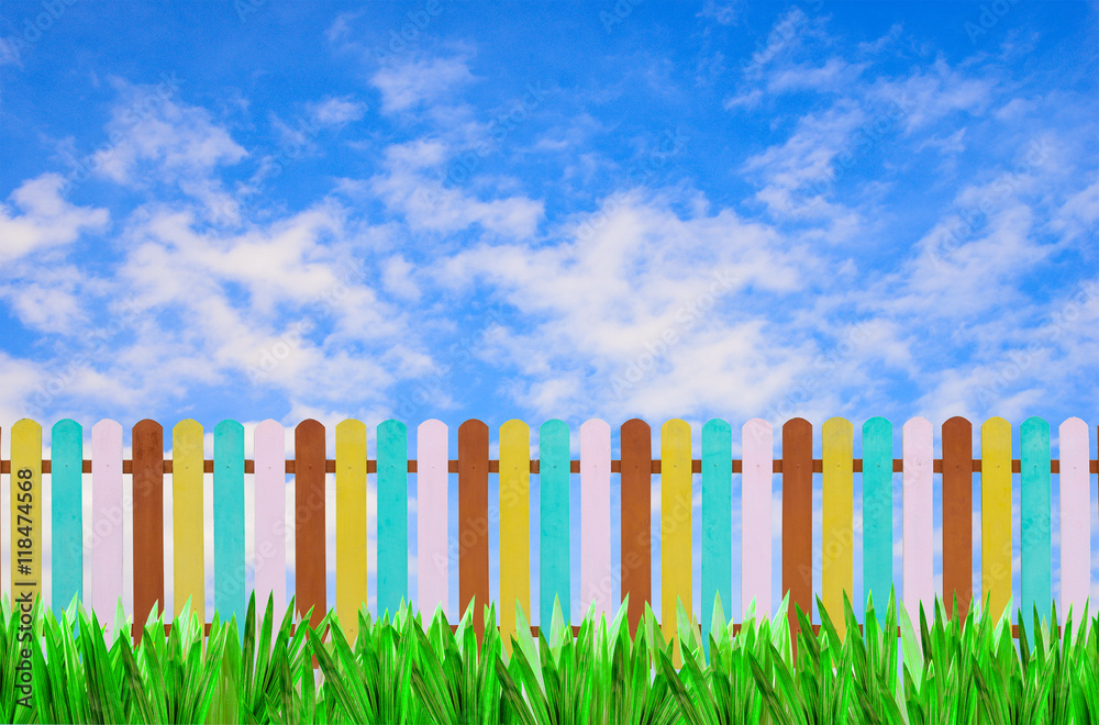 color fence with green grass and blue sky for background color fence with green grass and blue sky for background