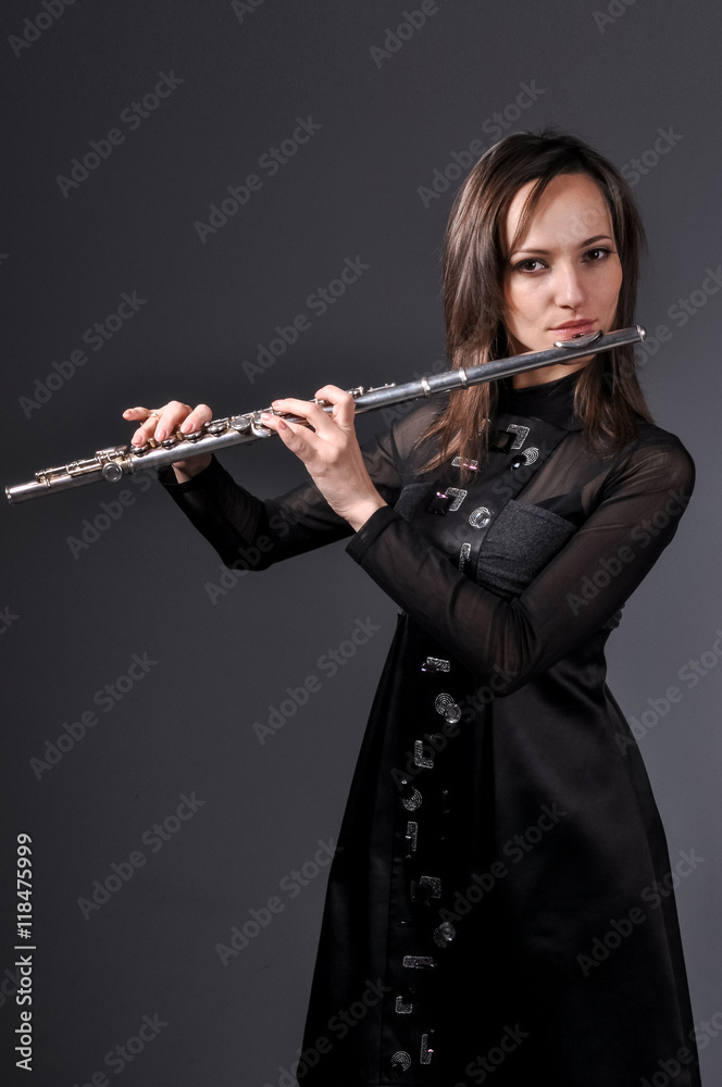 a young girl playing the flute