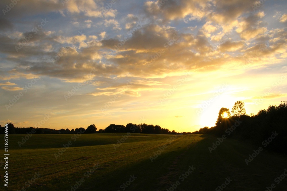 Sunset over green field in summertime Sunset over green field in summertime