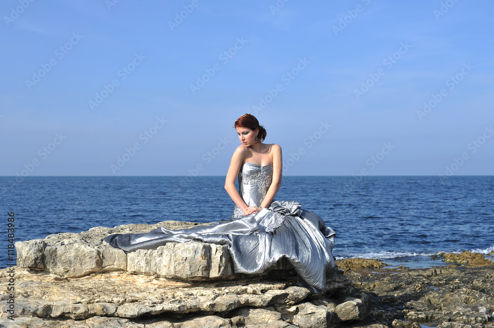 beautiful young fashion model posing on nature with fashion dress