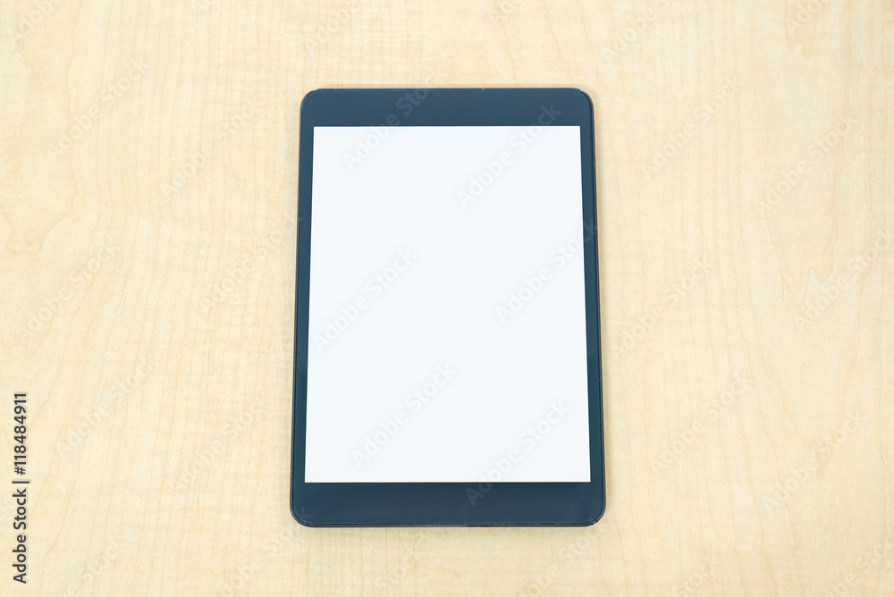 Digital tablet similar to ipade style on wood desk on top view. Digital tablet similar to ipade style on wood desk on top view.