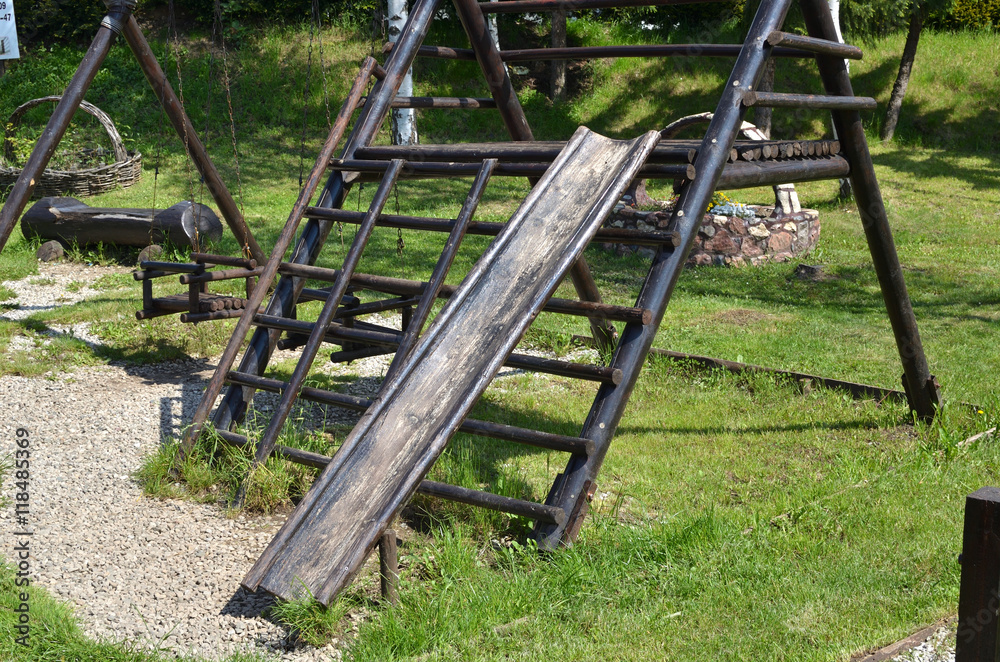 Handmade wooden slide of ethnic look in a village park Handmade wooden slide of ethnic look in a village park