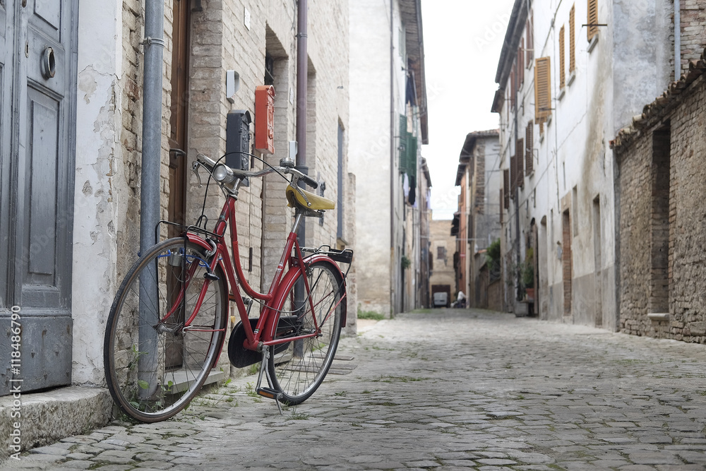 Urbania, Italy - August, 1, 2016: bicycle on a street in an ancient part of Urbania, Italy