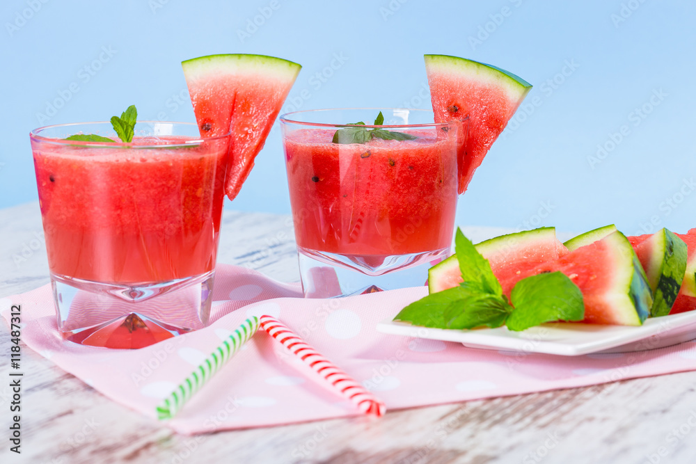 Glasses of watermelon smoothie on a wooden table Glasses of watermelon smoothie on a wooden table